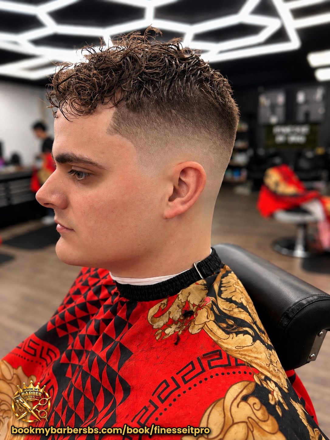 Low to mid skin fade with curly top. Styled with Lotta body mousse. Haircut done by @jerz_the _barber